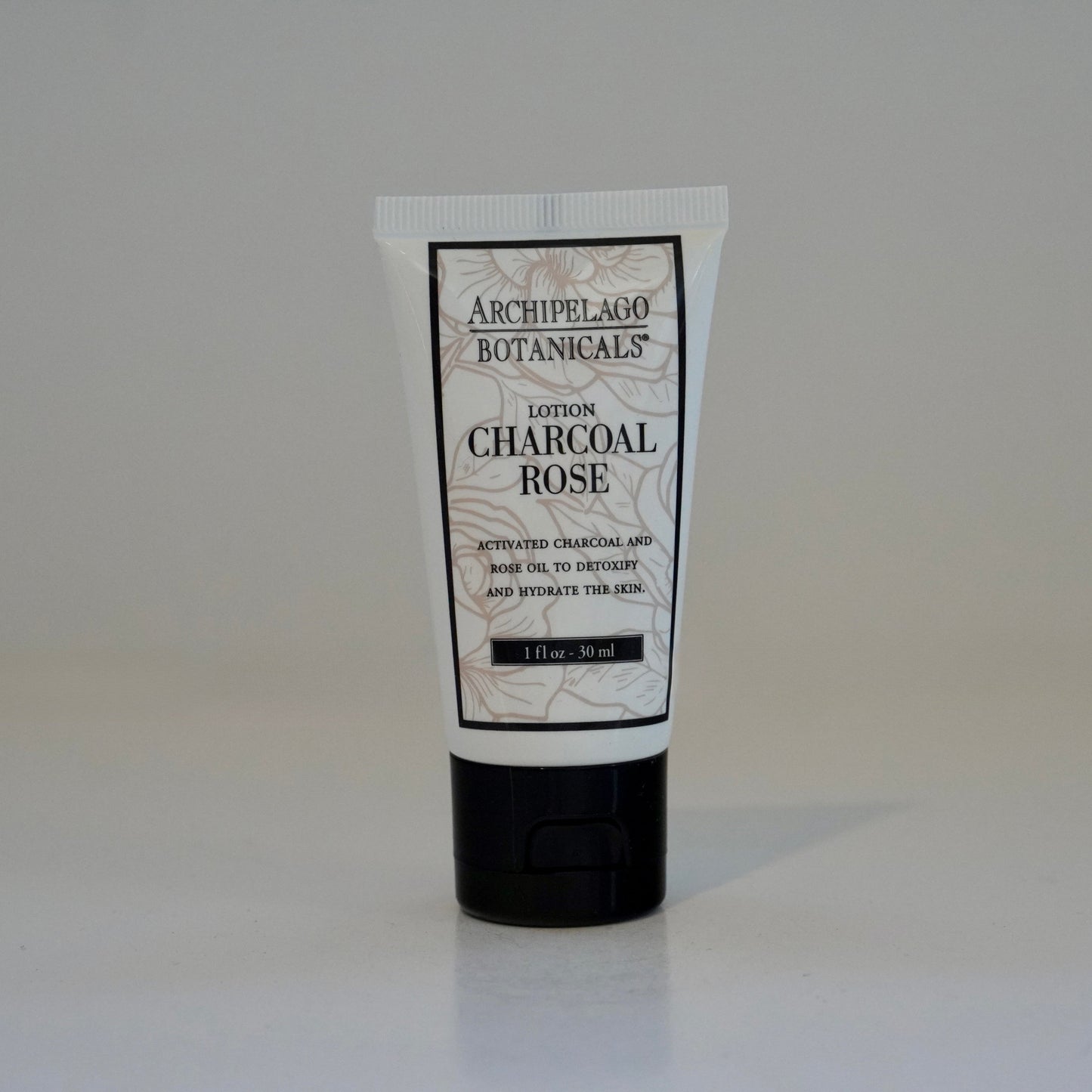 Tube of Archipelago Botanicals Charcoal Rose Lotion on a white background