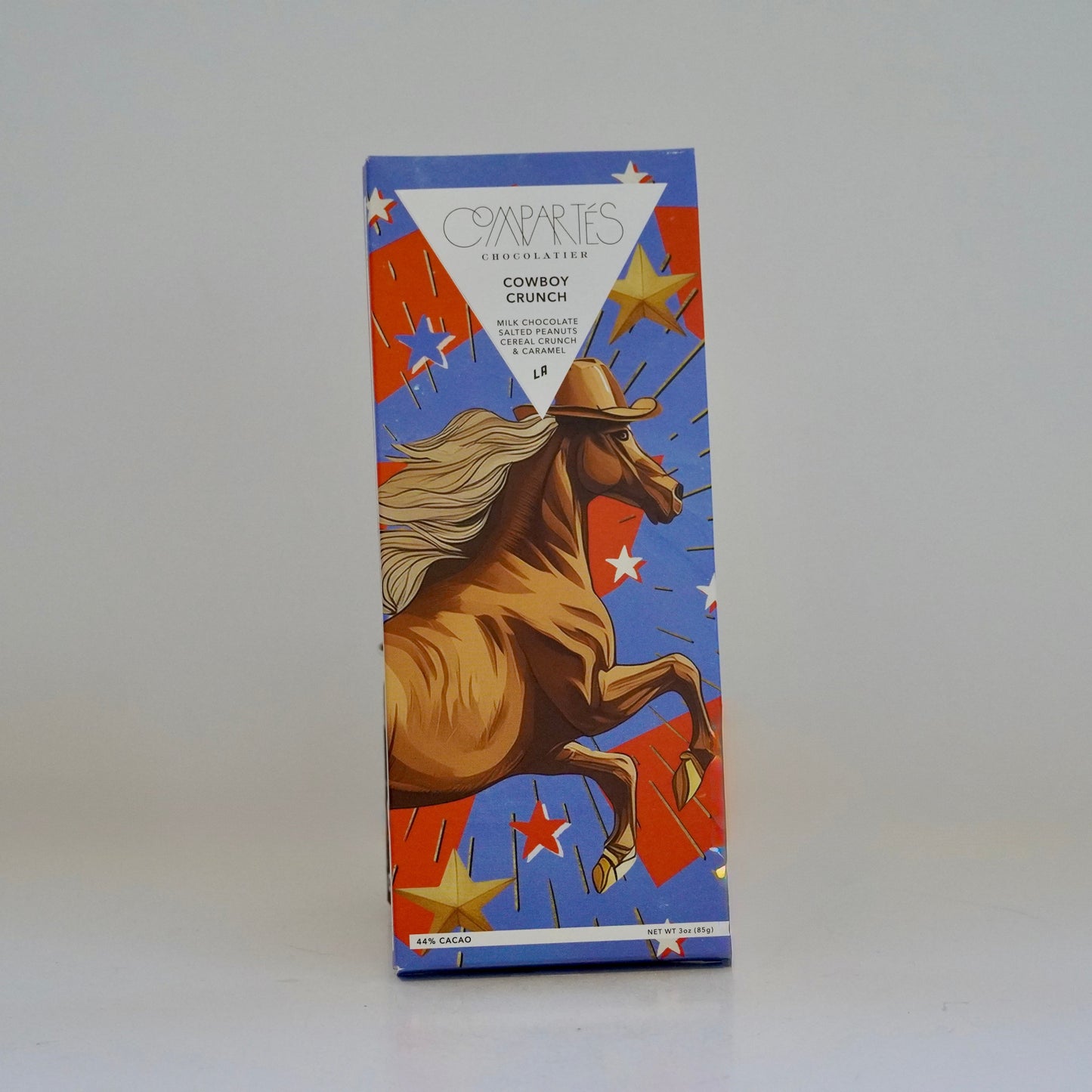 Box with a graphic of a cowboy on a horse against a blue background