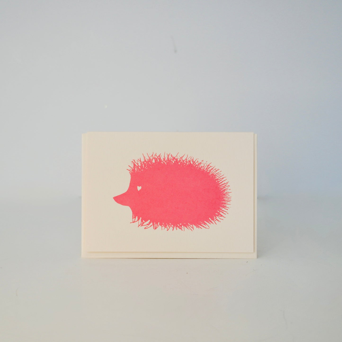 Note card with a red hedgehog illustration on a light gray background