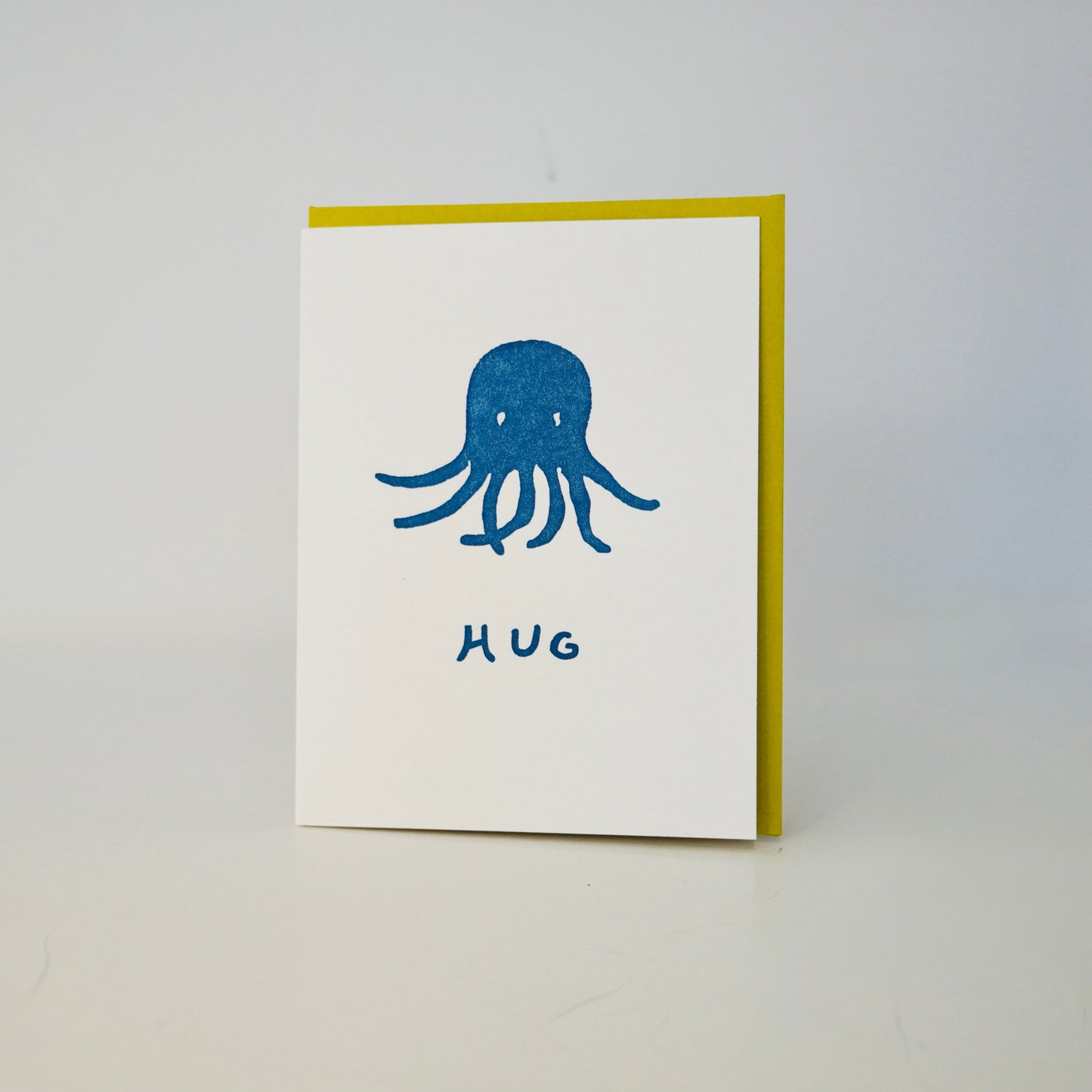 Card with an octopus illustration and 'Hug' text on a gray background