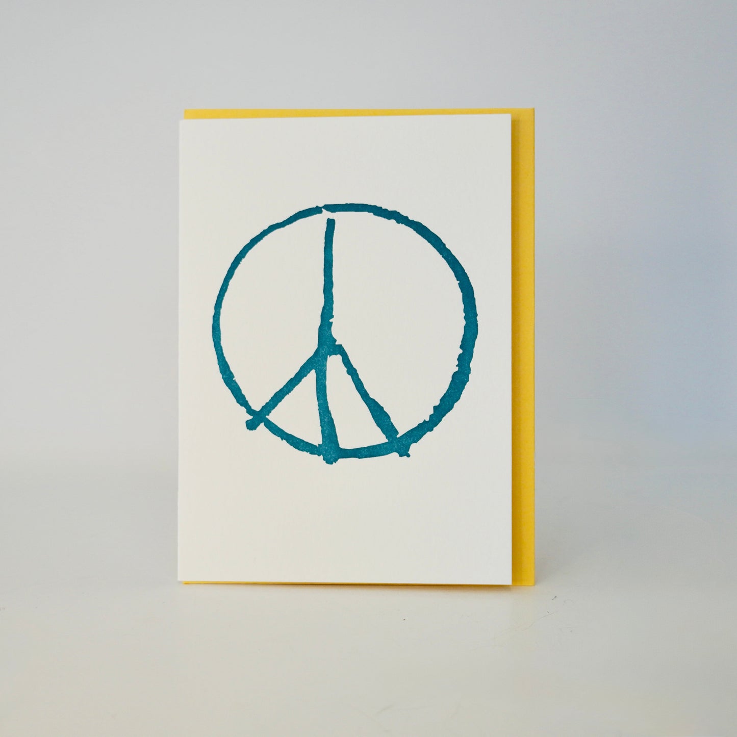 Card with peace symbol on a plain background
