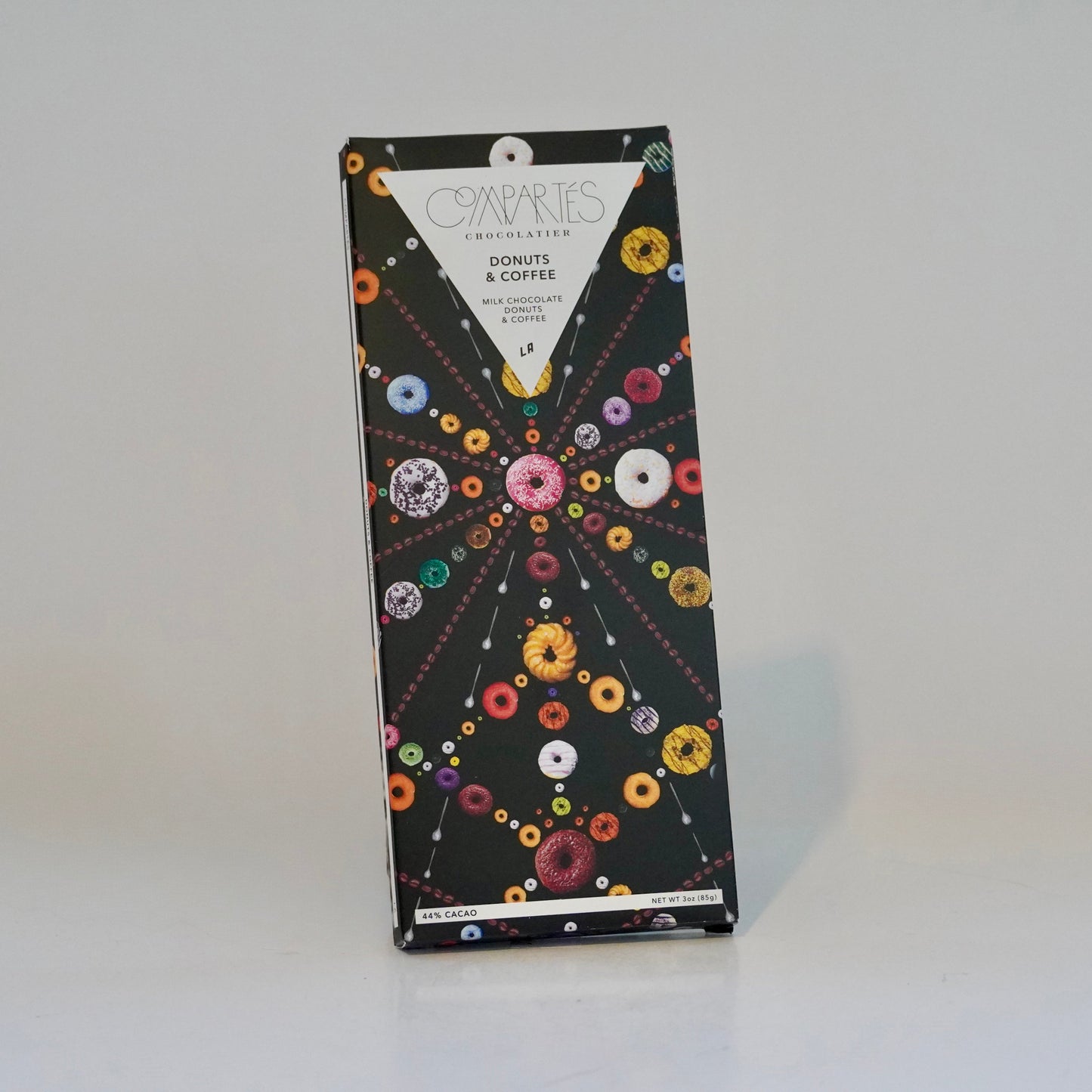 Box of donuts and coffee with colorful donut illustrations on a white background