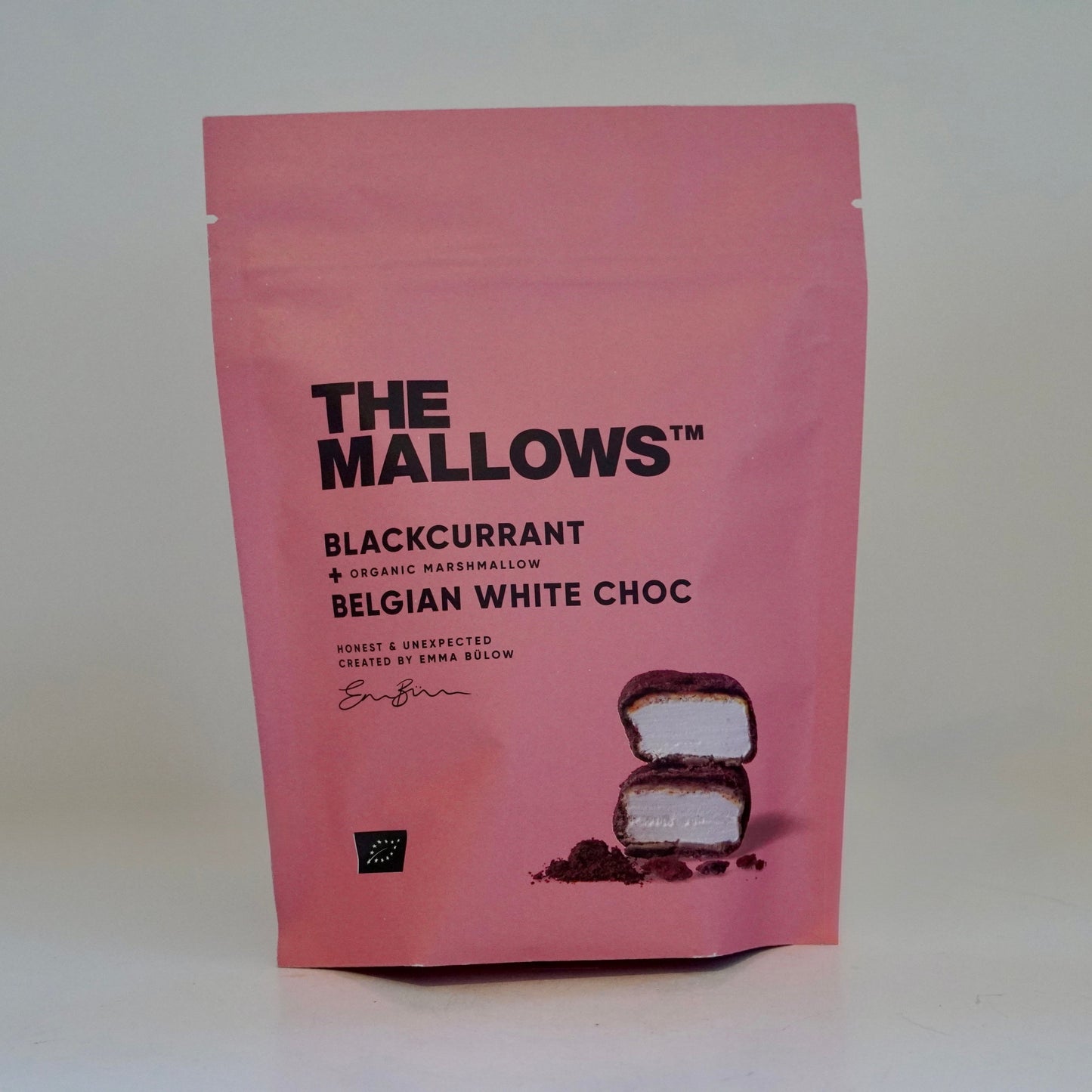 Pink package of 'The Mallows' blackcurrant Belgian white choc on a white background
