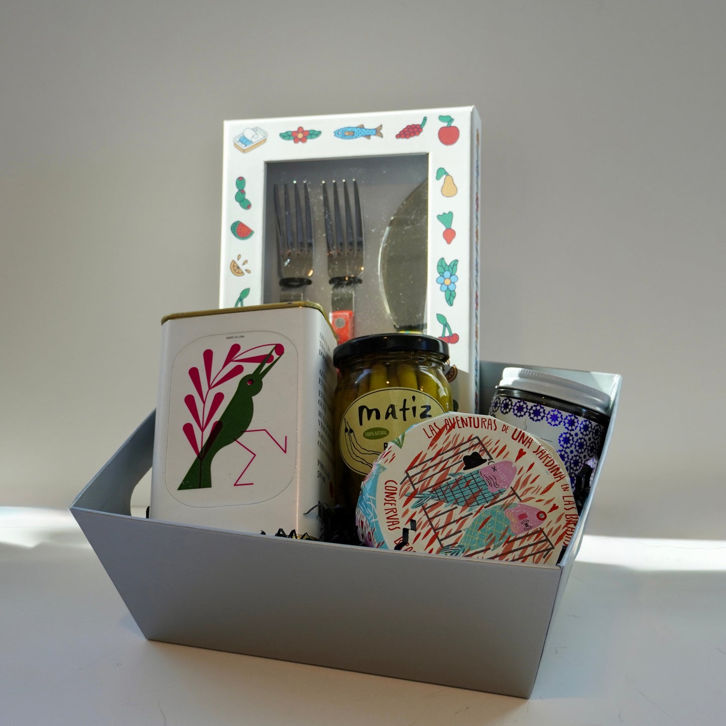 Set of items in decorative box on a white surface.