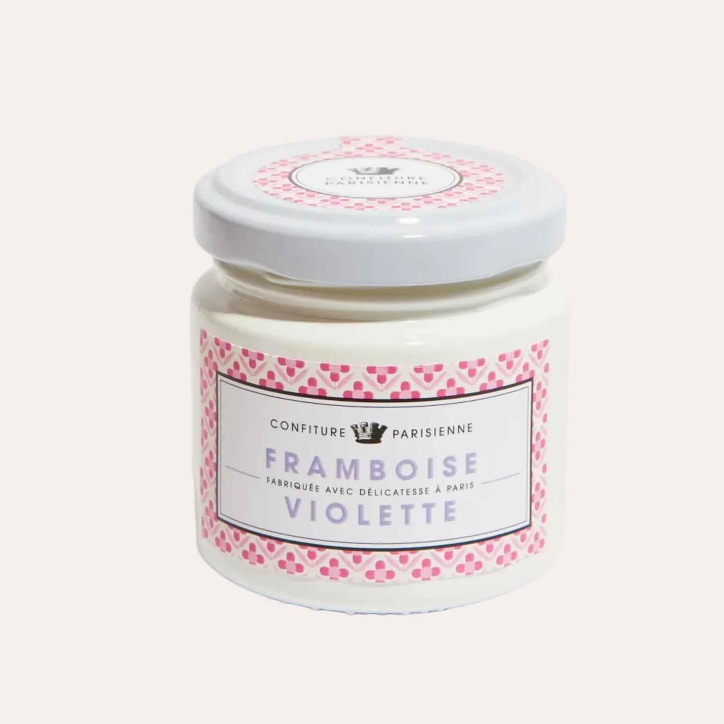 Jar of confiture with a pink and white label on a light gray background