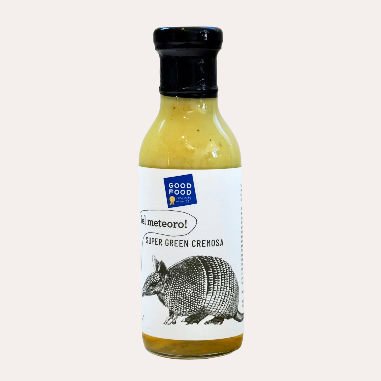 Bottle of Super Green Cremosa sauce with an armadillo illustration on a white background