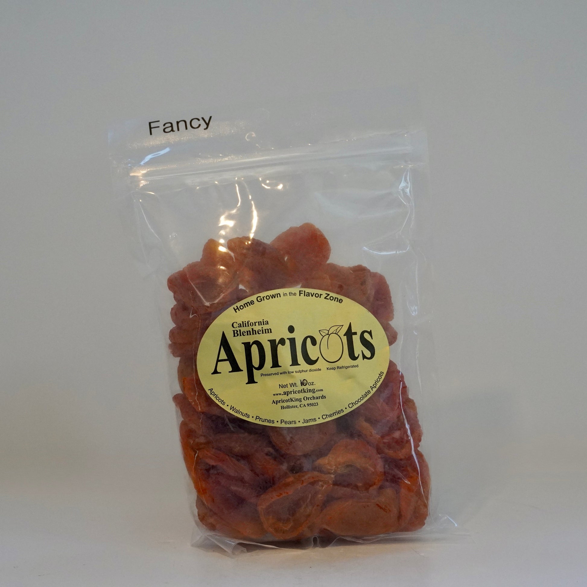 Packaged apricots with a label on a white background