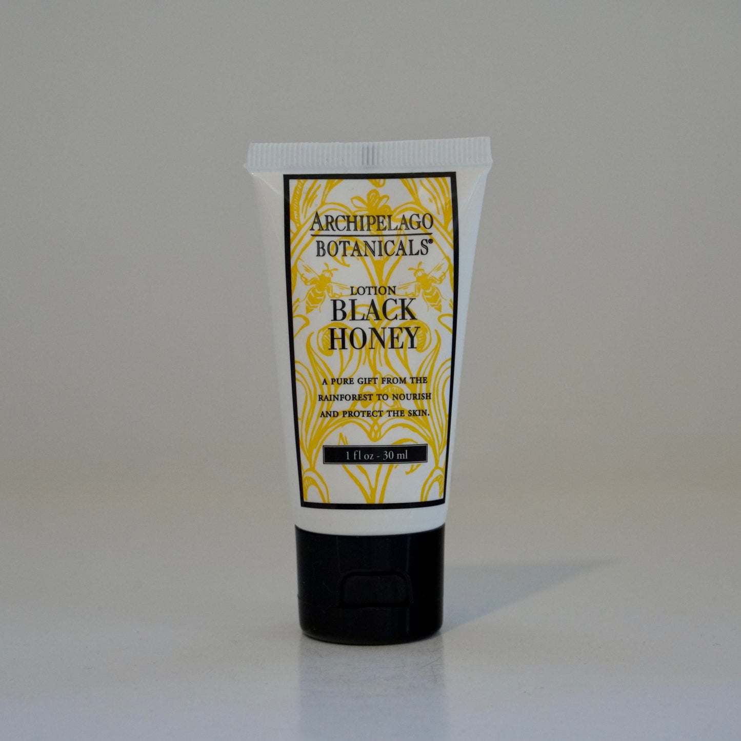 Tube of Archipelago Botanicals Black Honey Lotion on a white background