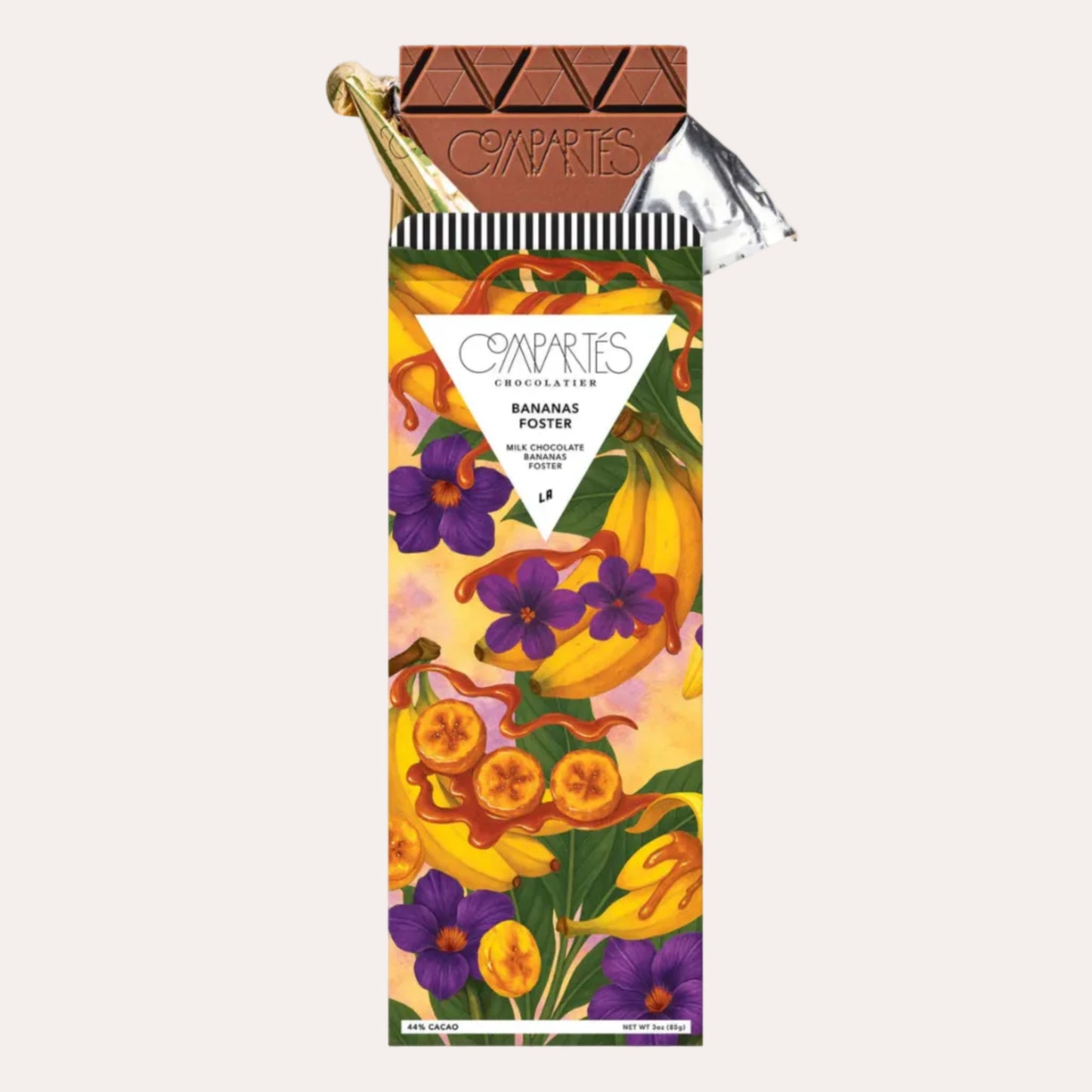 Chocolate bar with a colorful packaging featuring bananas and flowers on a light gray background