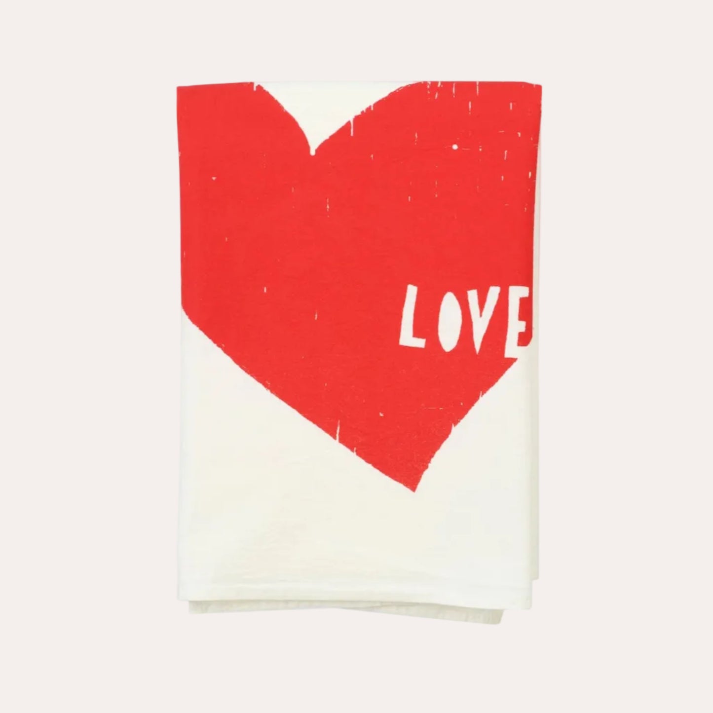 Folded fabric with a red heart and 'LOVE' text on a white background