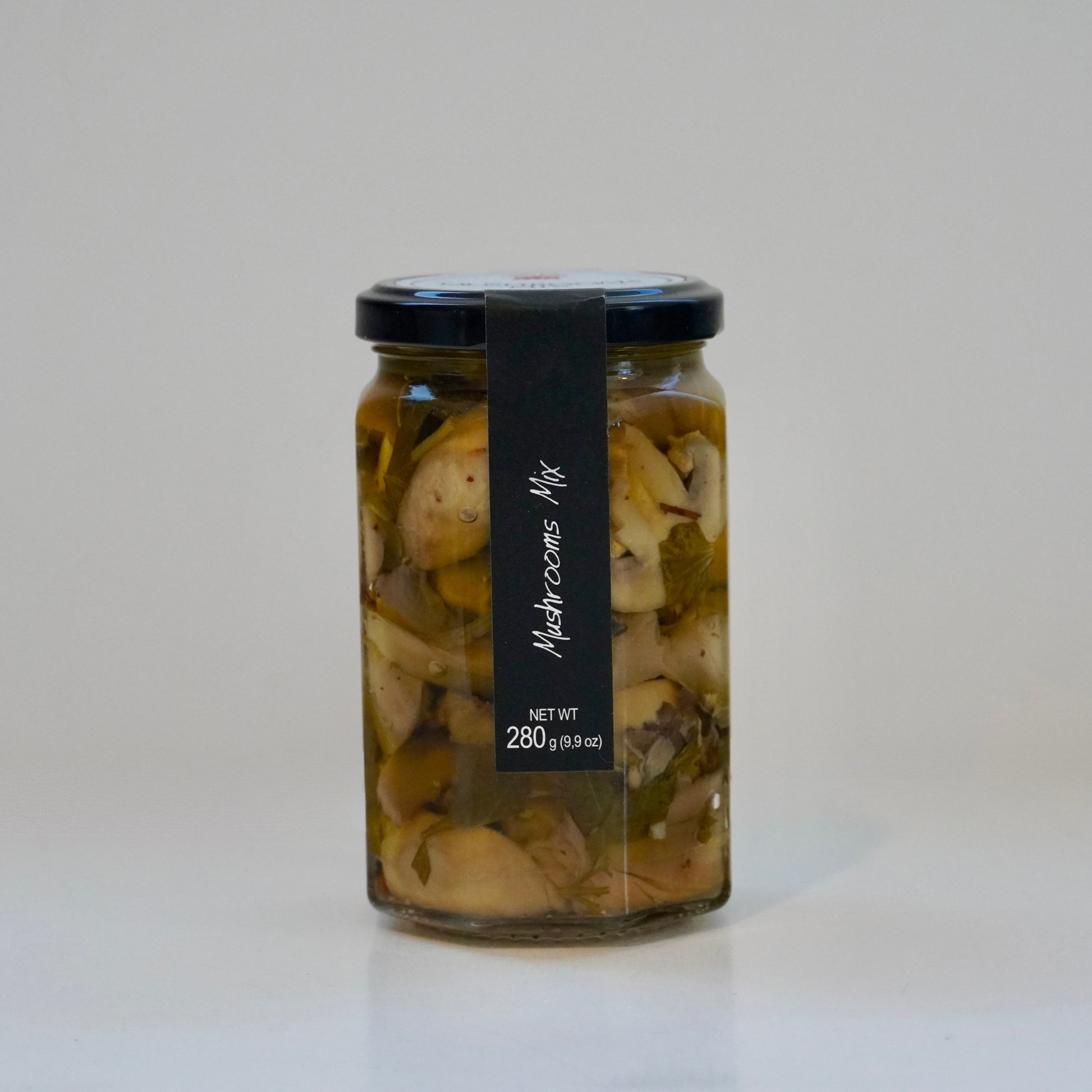 Jar of pickled mushrooms with a black label on a white background