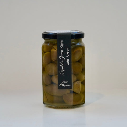 Jar of green olives with a black label on a white background