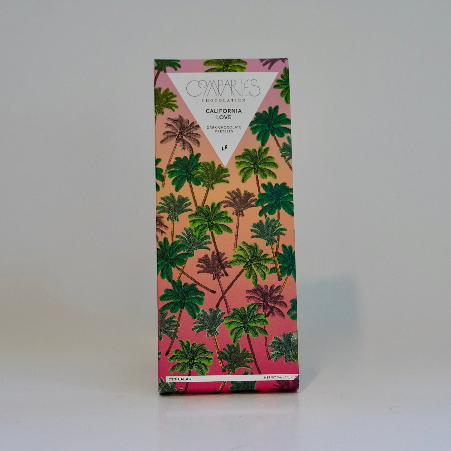 Product packaging with palm tree design on a pink background