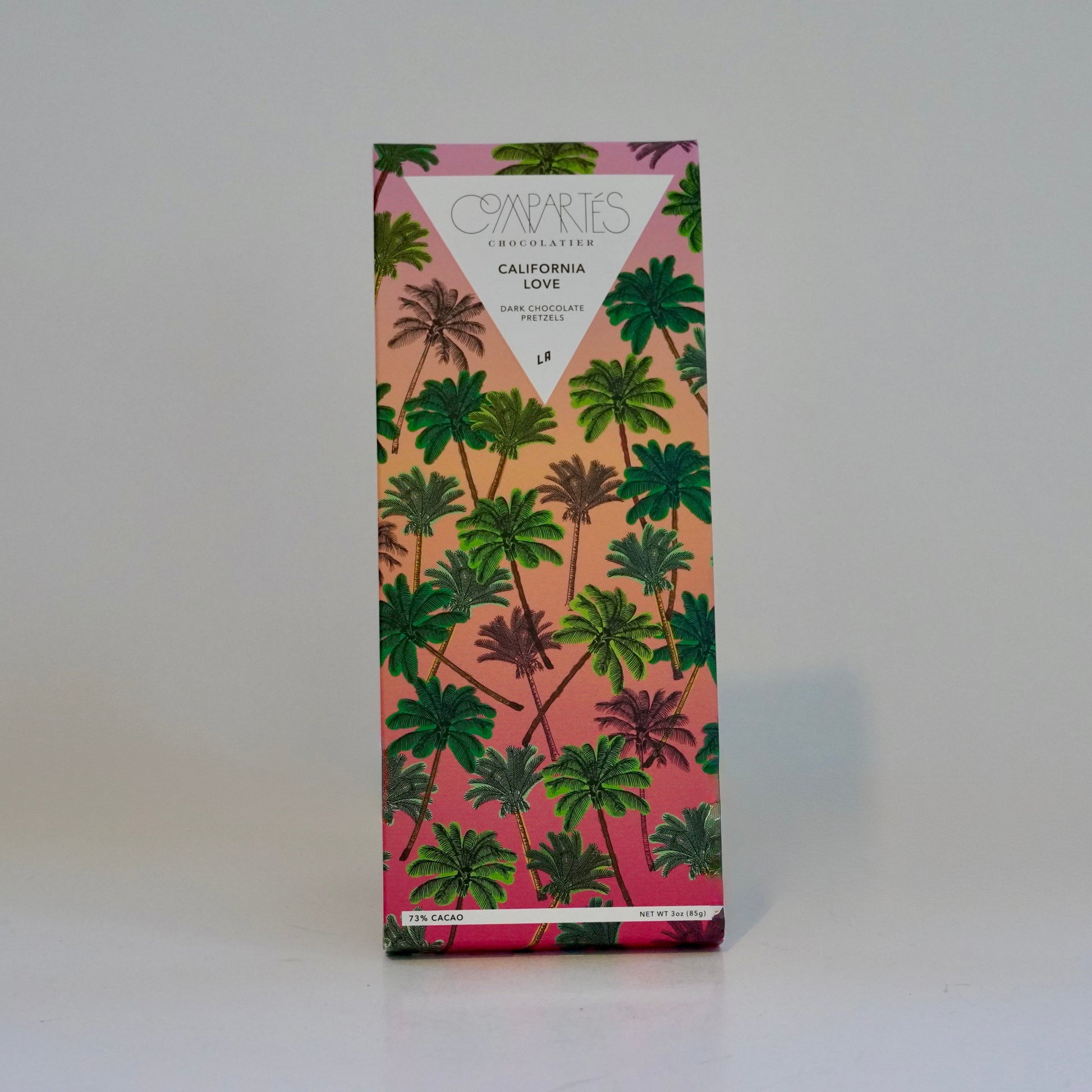 Product packaging with palm tree design on a pink background