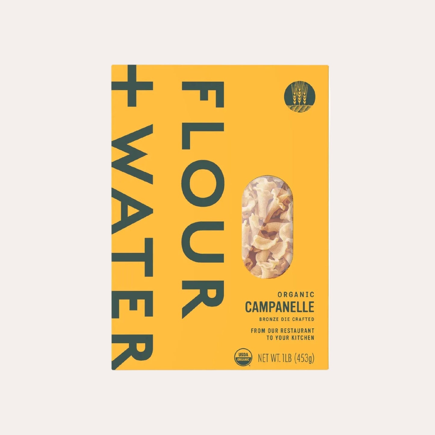 Box of Flour + Water organic campanelle pasta on a yellow background