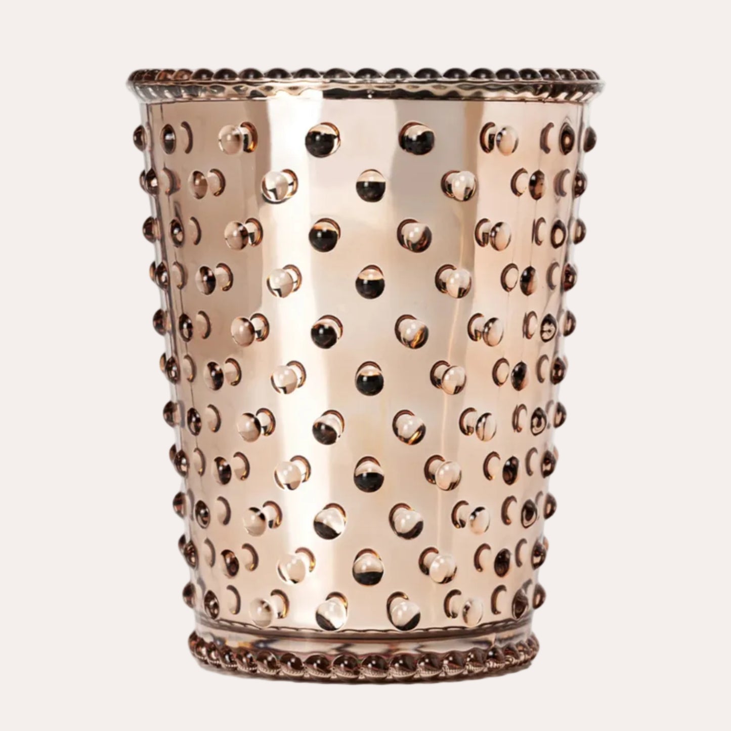 A metallic rose gold decorative cup with a perforated design, featuring a beaded rim and base, set against a plain white background.
