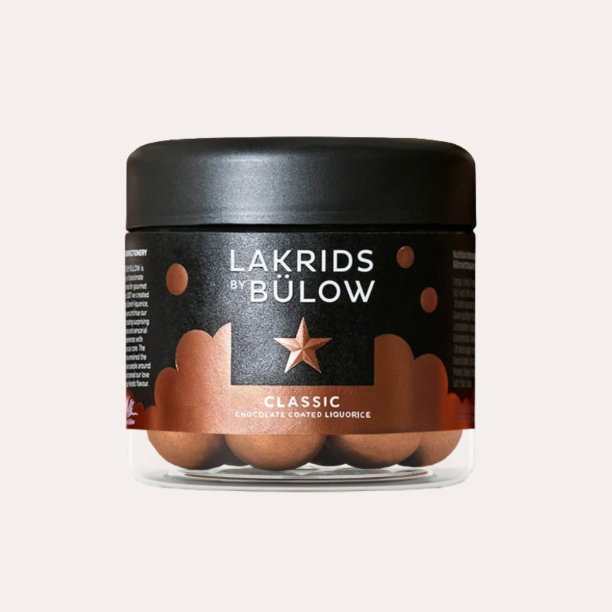 A jar of Lakrids by Bölow Classic Lip Tint in a clear container showing the brown tinted wax inside, with a black lid and black label on a light beige background.