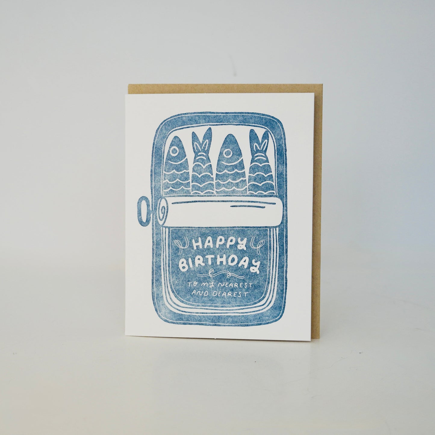 Greeting card with blue fish illustration and 'Happy Birthday' text on a white background