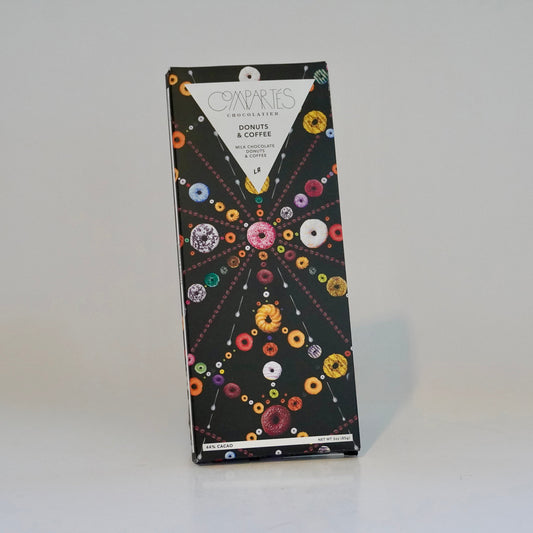 Box of donuts and coffee with colorful donut illustrations on a white background