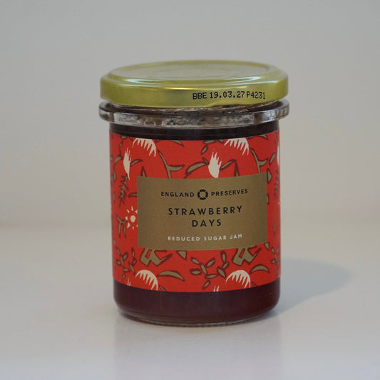 Jar of strawberry jam with a decorative label on a white background