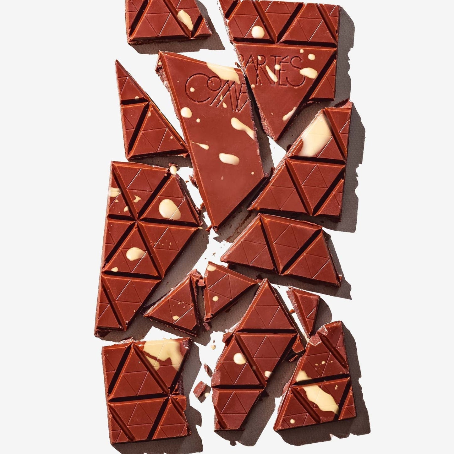 Broken chocolate bar with visible brand name on a light background