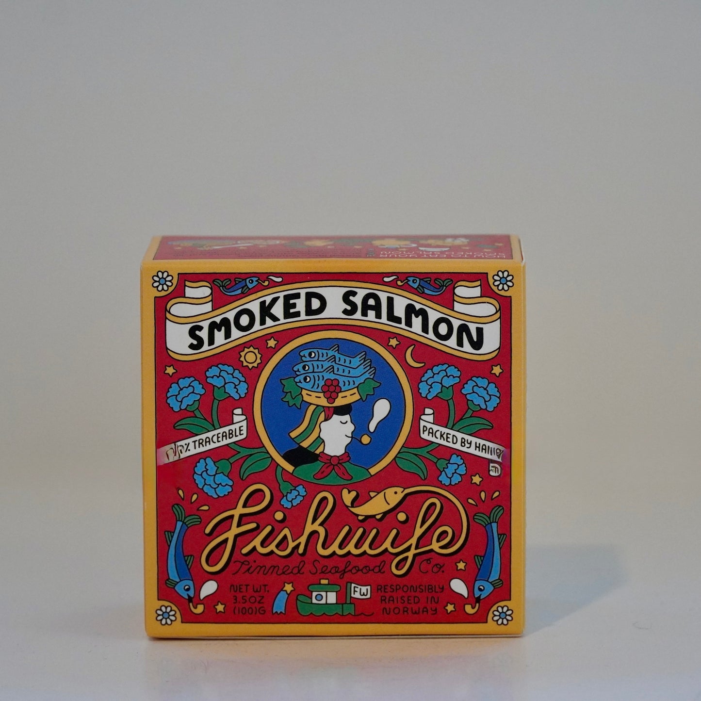 Box of smoked salmon with colorful design on a gray background