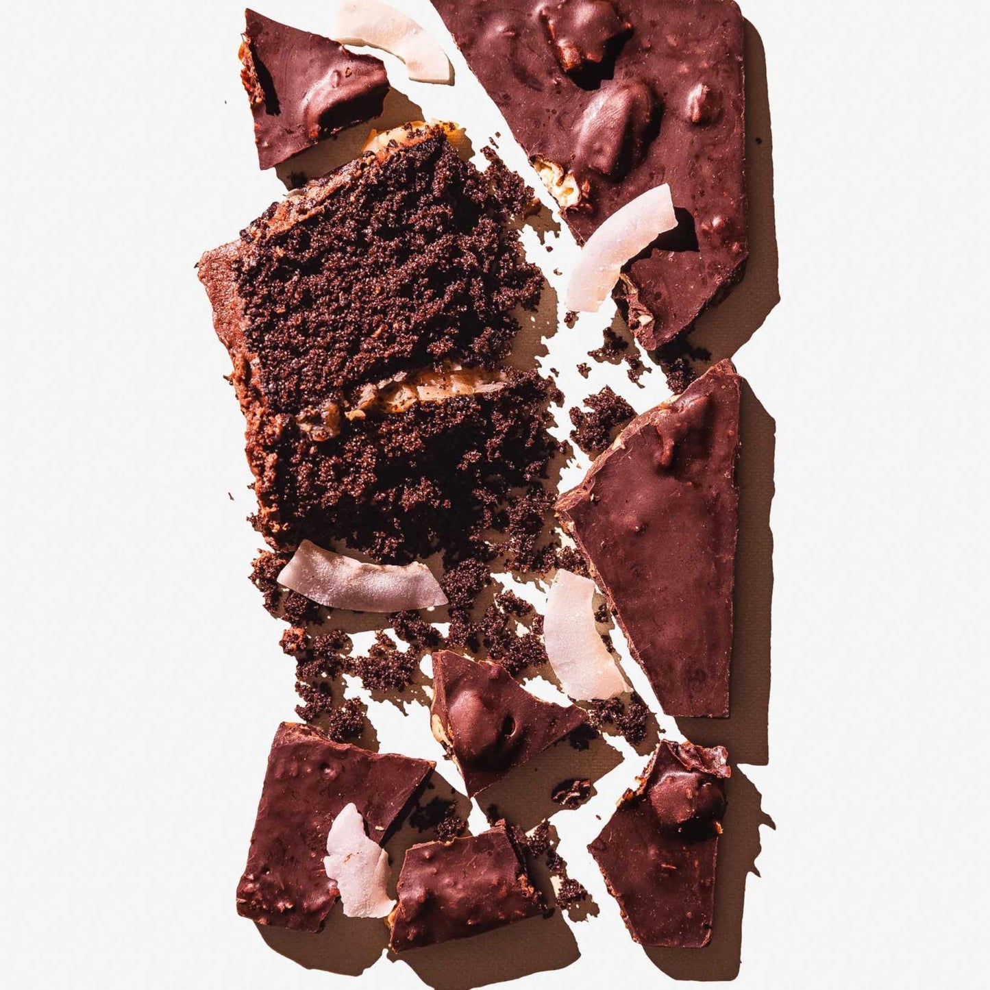 Chocolate cake with pieces on a white background