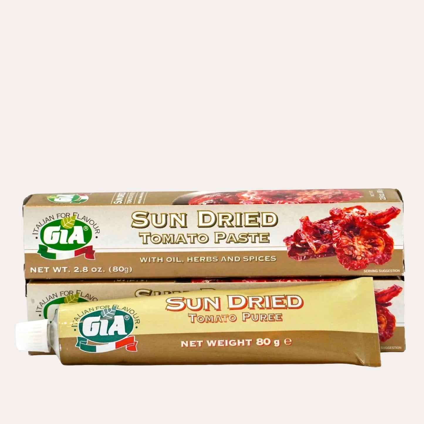 Two tubes of Gia sun dried tomato products on a white background
