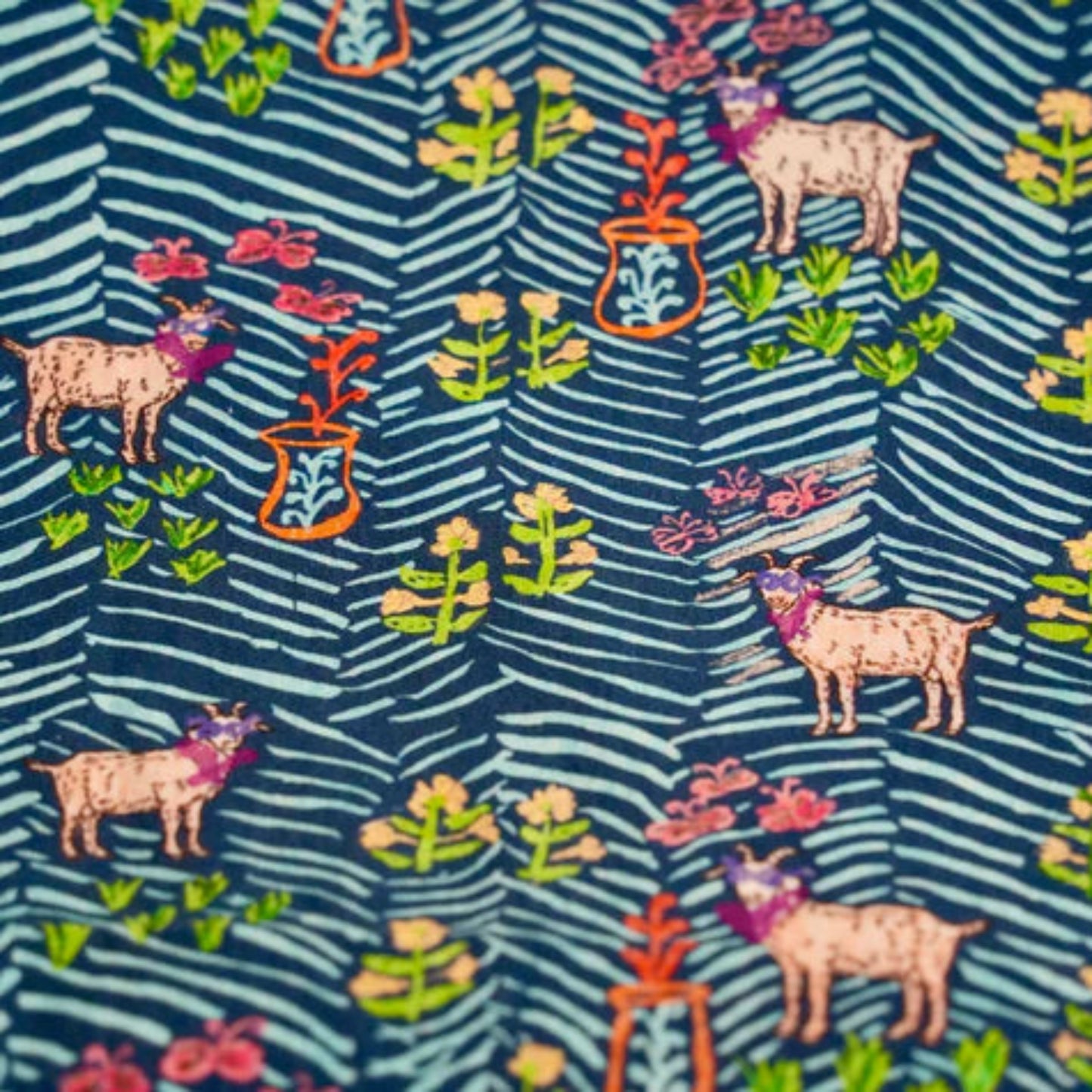Patterned fabric with animals and plants on a blue background