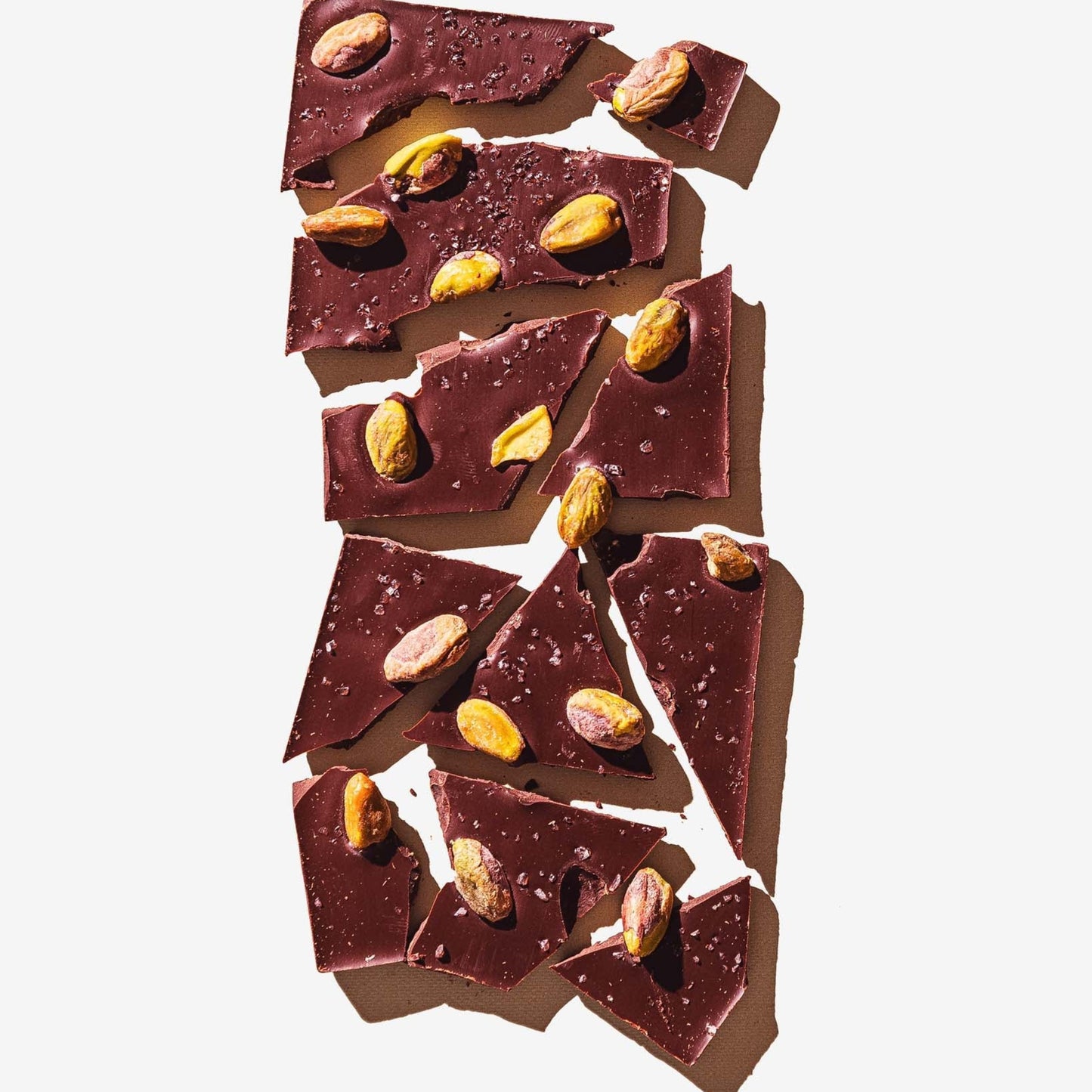 Dark chocolate bark with nuts on a white background