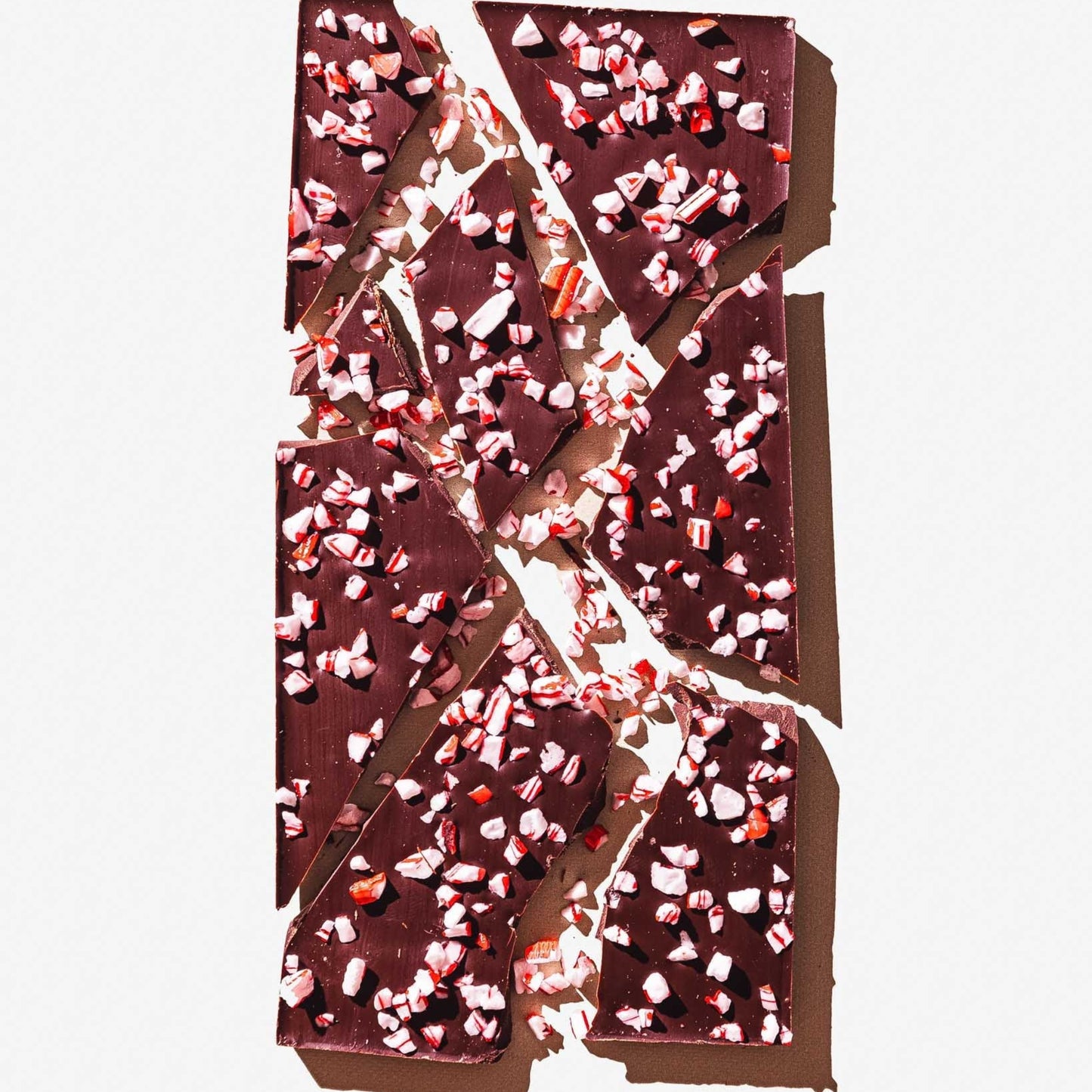 Chocolate bar with peppermint pieces on a white background
