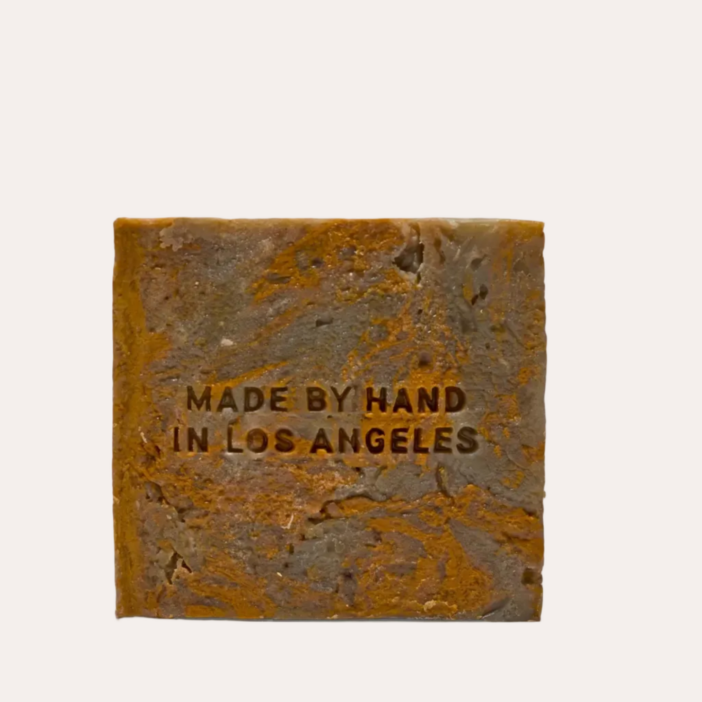 Bar of soap with 'Made by Hand in Los Angeles' text on a white background