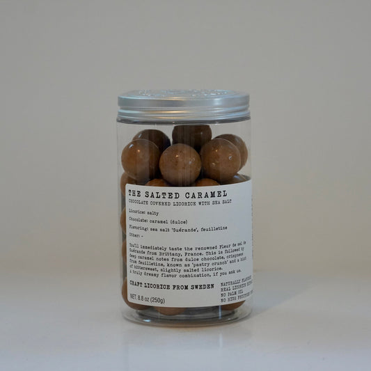 Jar of salted caramel candies with a label on a white background