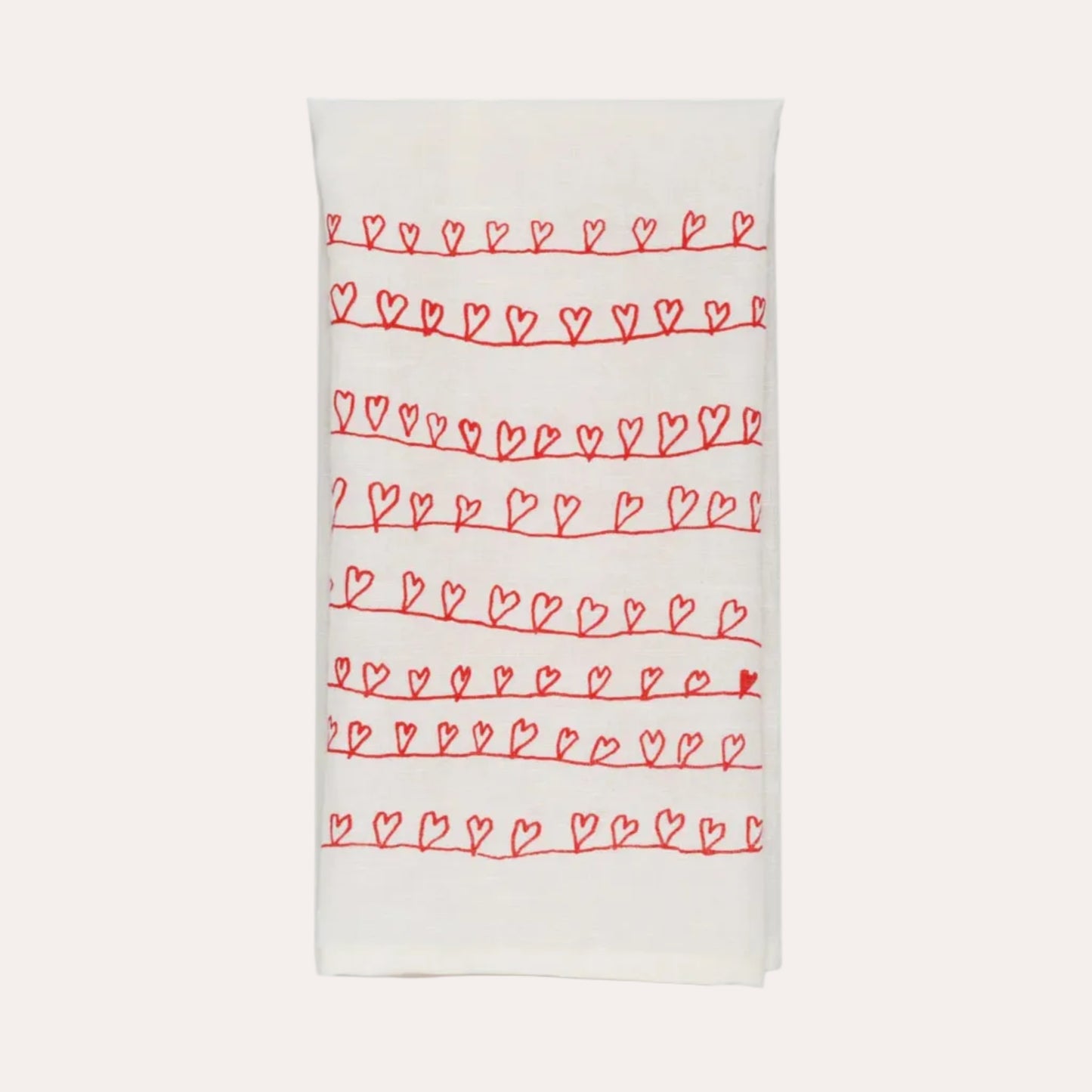 White towel with red heart patterns on a white background