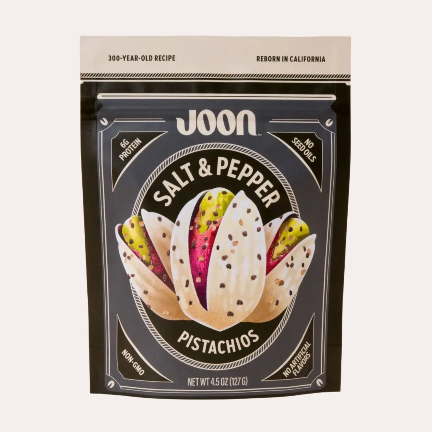 Packaging of Joon Salt & Pepper Pistachios on a light pink background