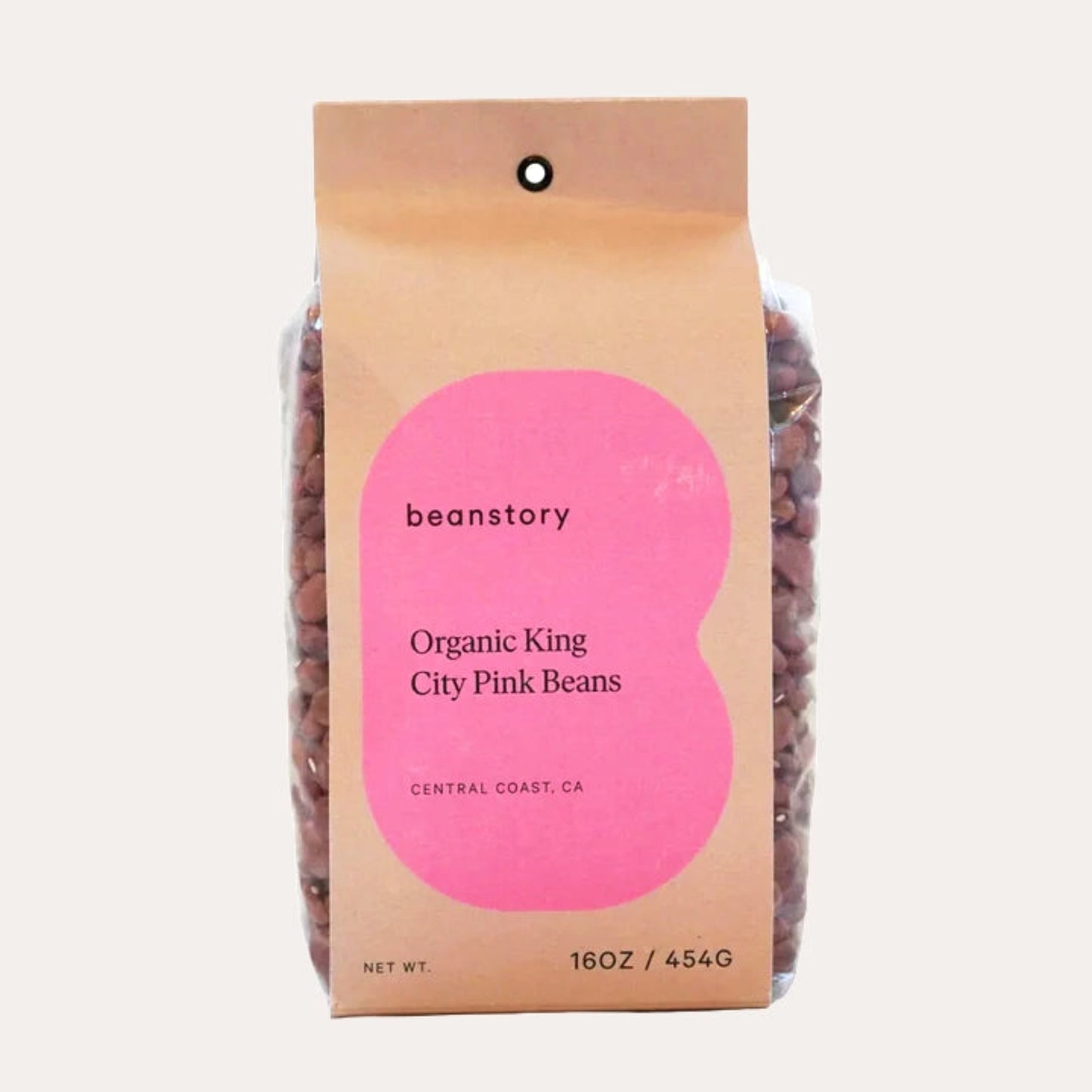 Bag of organic king city pink beans with a pink label on a light beige background