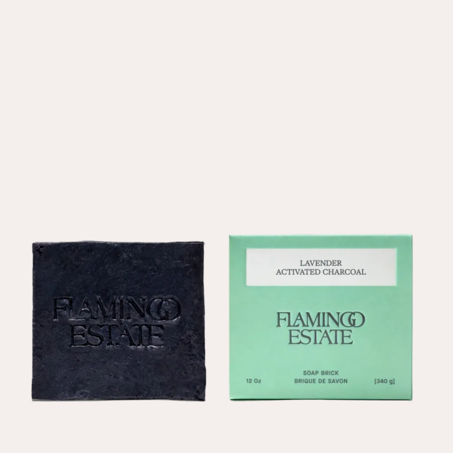 Black soap bar and green packaging of Flamingo Estate on a white background