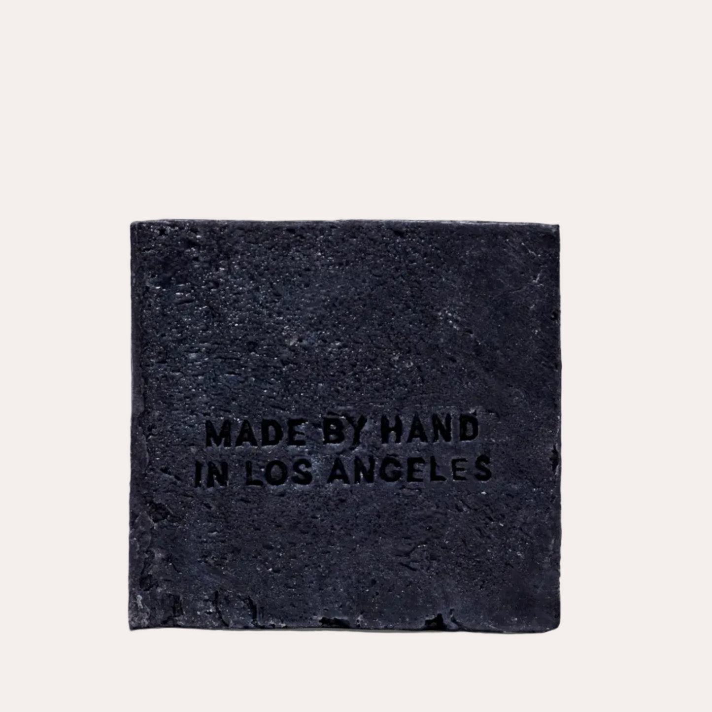 Black square stone with 'MADE BY HAND IN LOS ANGELES' text on a light gray background