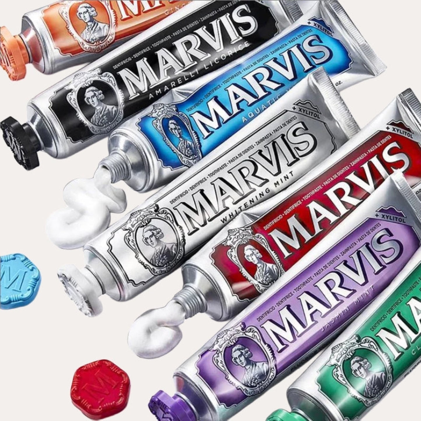 Multiple tubes of Marvis toothpaste in various flavors on a white background