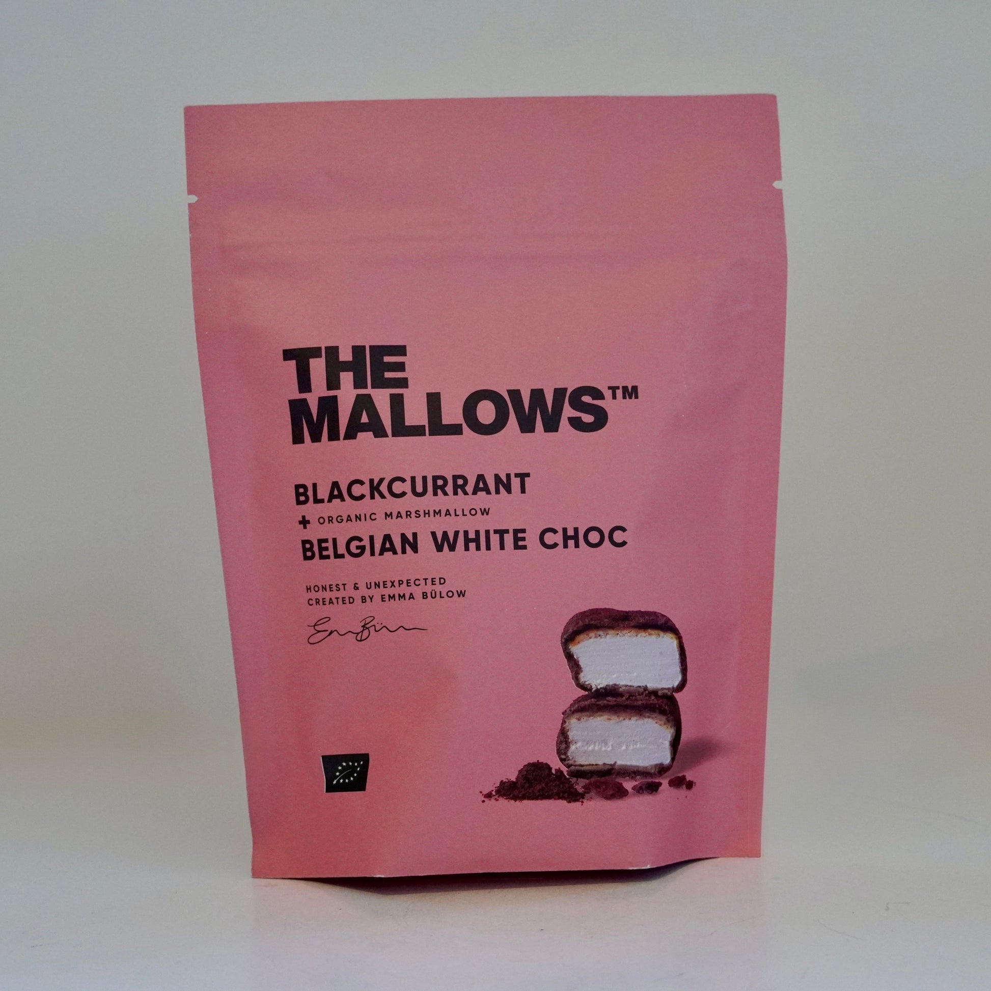 Pink package of 'The Mallows' blackcurrant Belgian white choc on a white background