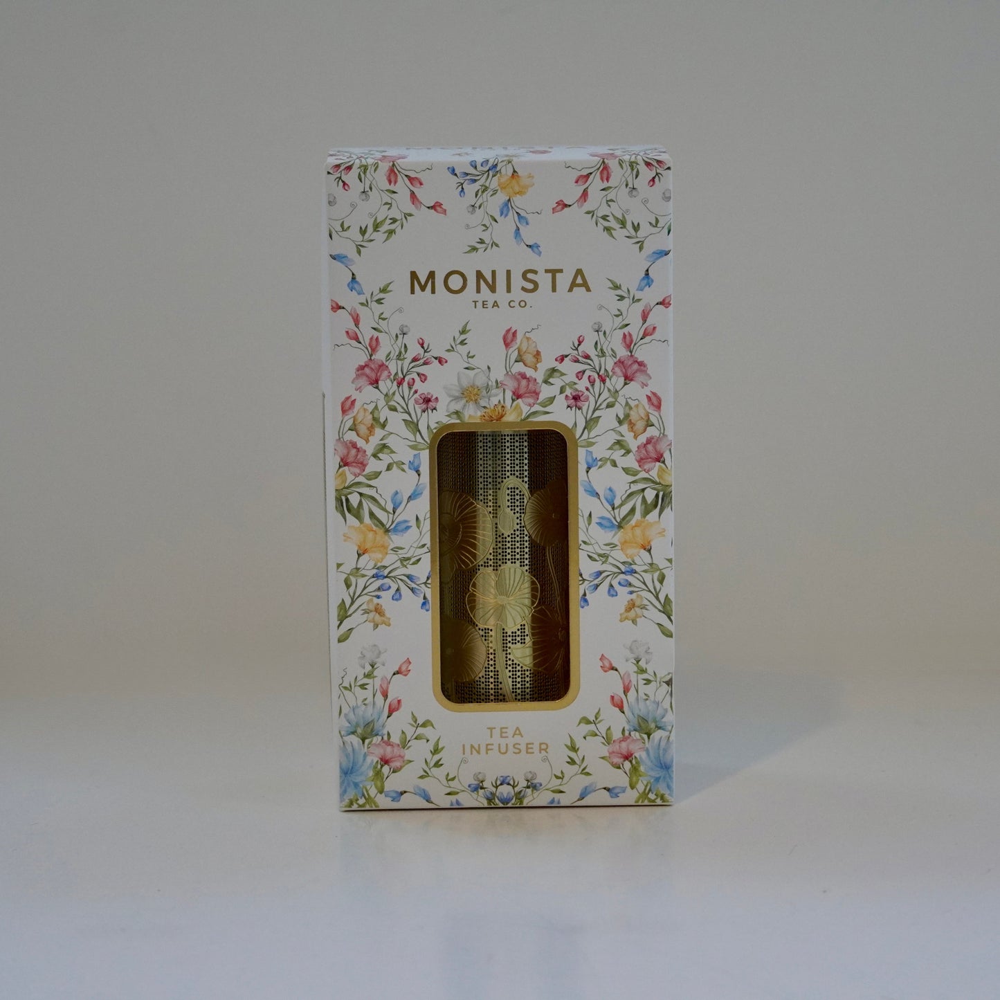 Floral-patterned box with 'MONISTA' branding on a white background