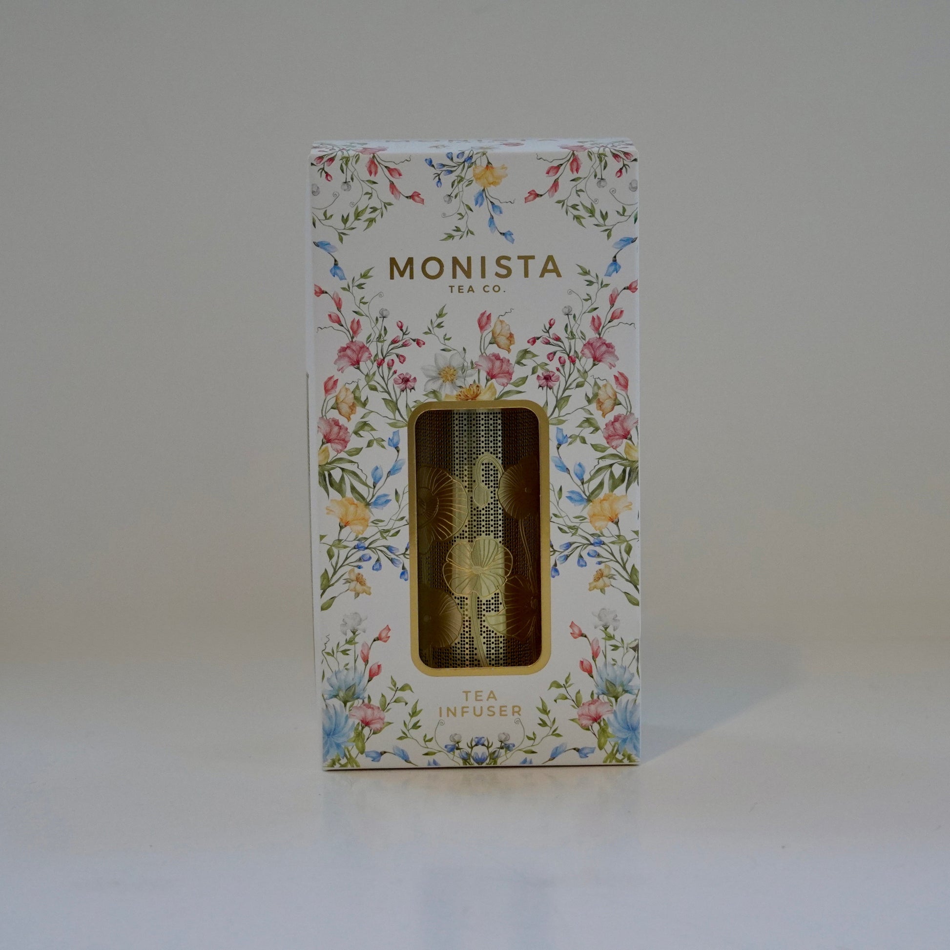 Floral-patterned box with 'MONISTA' branding on a white background