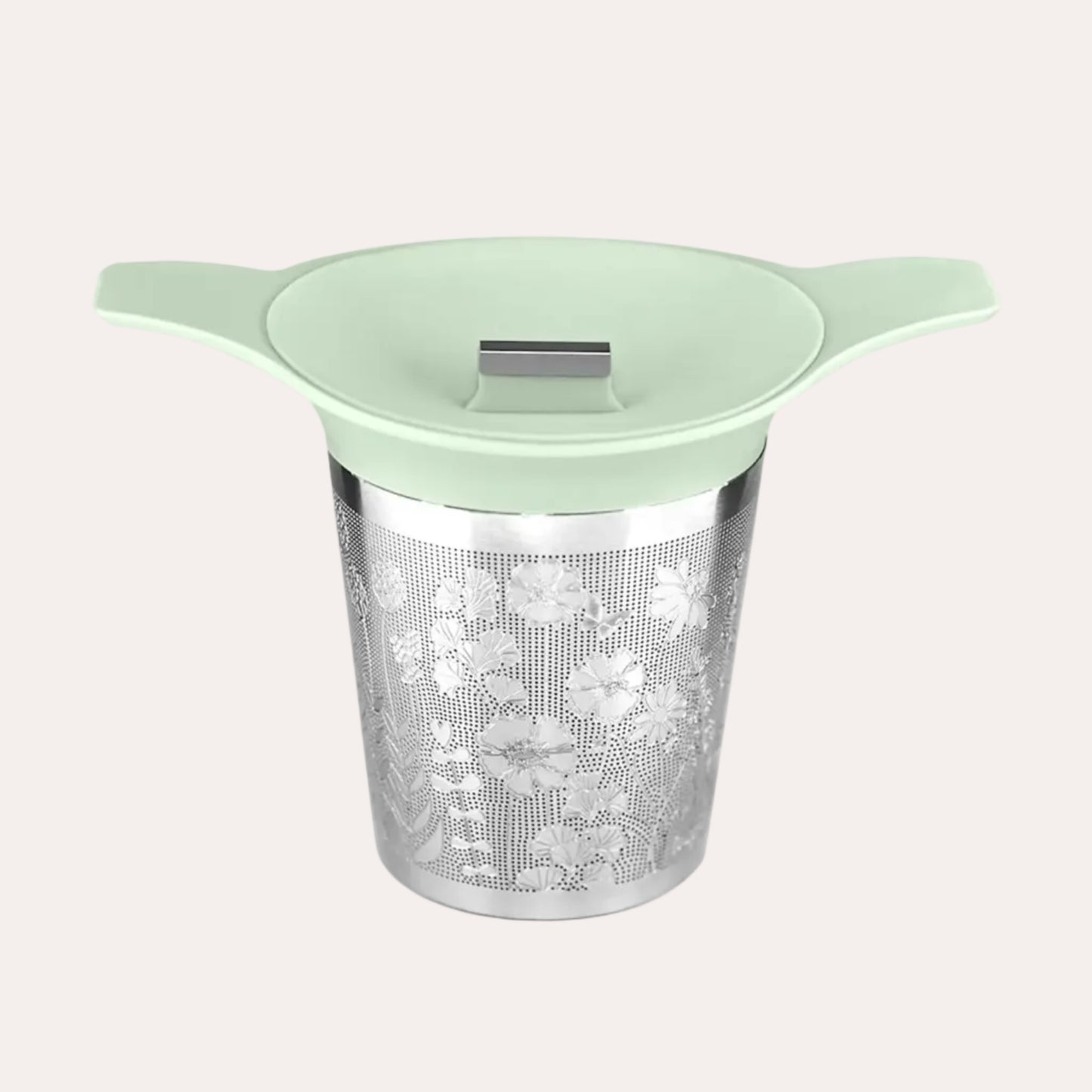 Tea infuser with green lid on a white background