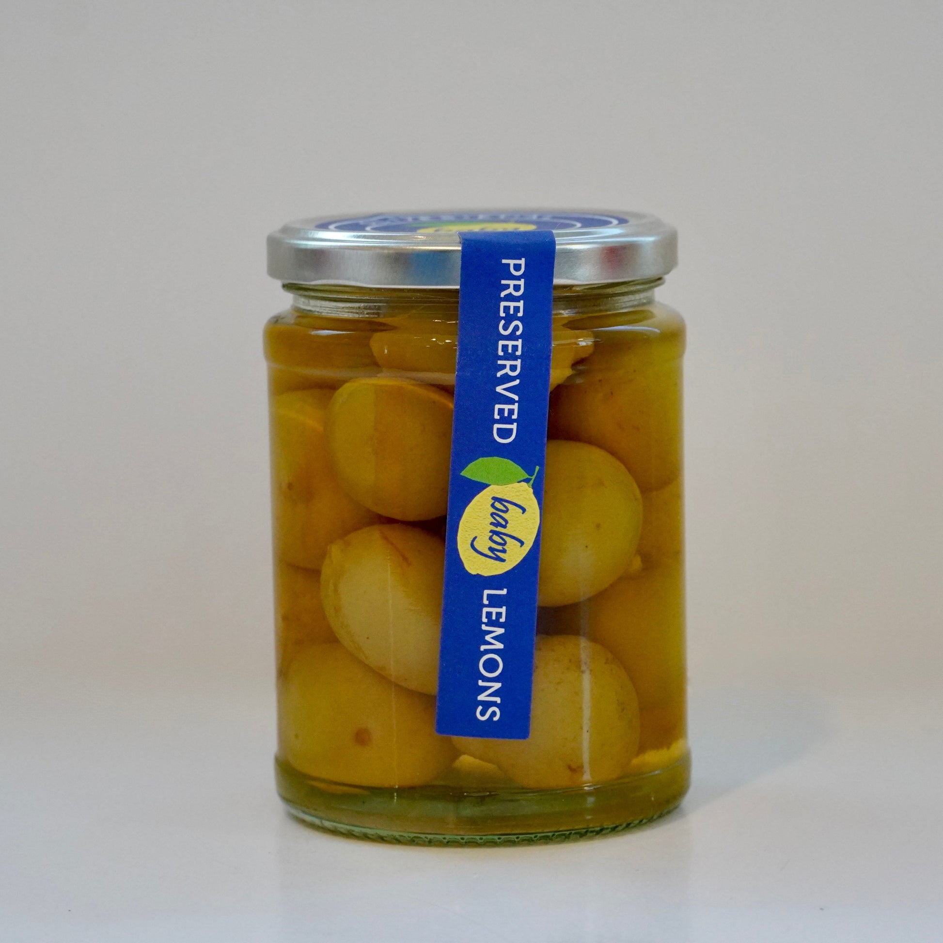 Jar of preserved lemons with a blue label on a white background