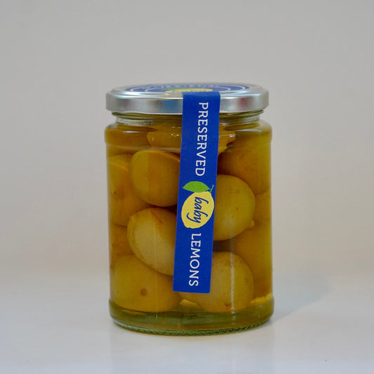 Jar of preserved lemons with a blue label on a white background