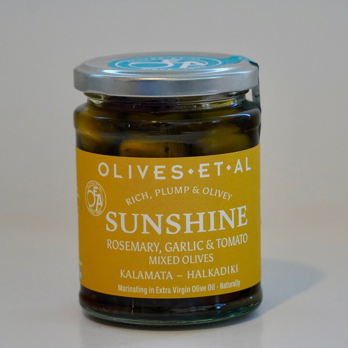 Jar of 'Sunshine' olives with a yellow label on a white background