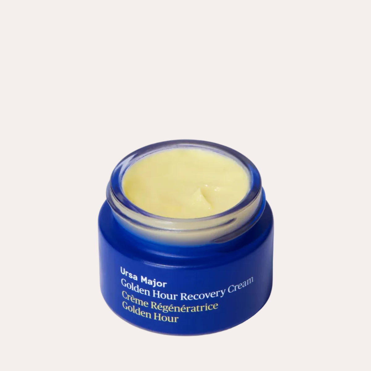 Blue jar of Ursa Major Golden Hour Recovery Cream on a white background