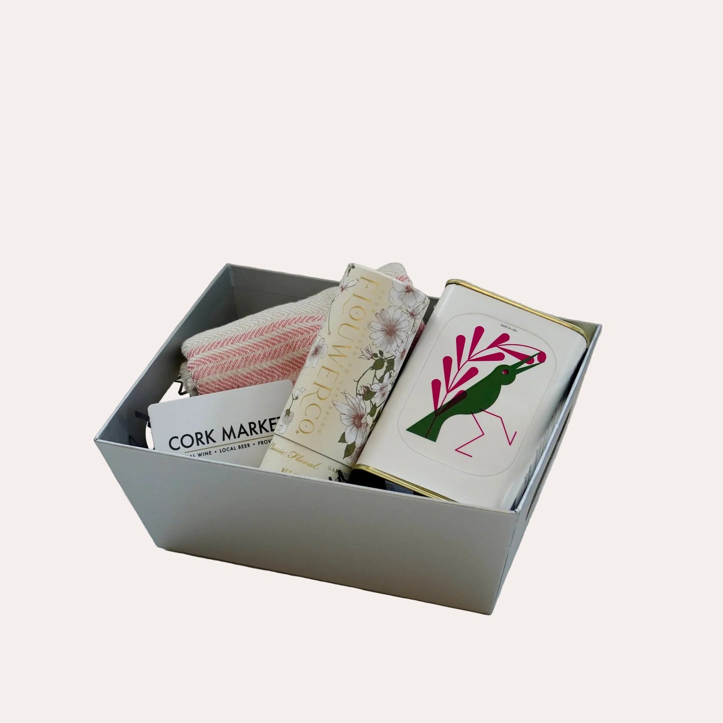 Box containing various items including a book with a bird illustration on a white background