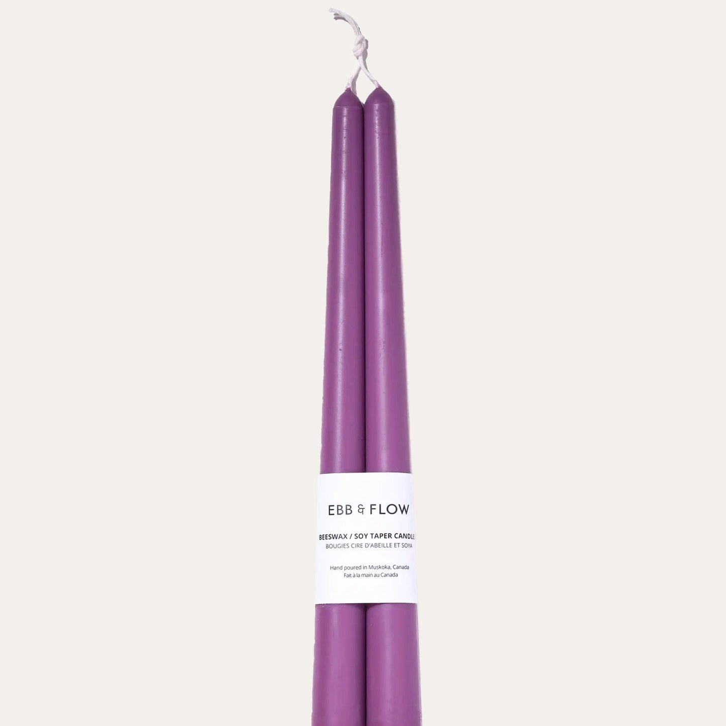 Purple candles with packaging on a white background