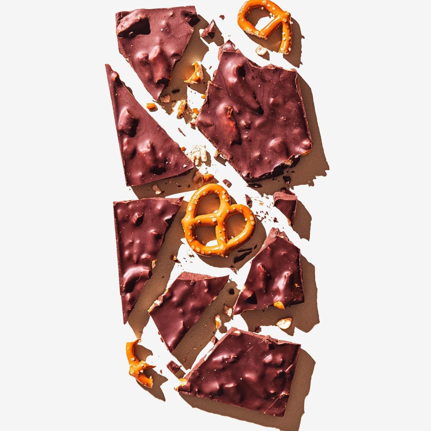 Chocolate bark with pretzel pieces on a white background
